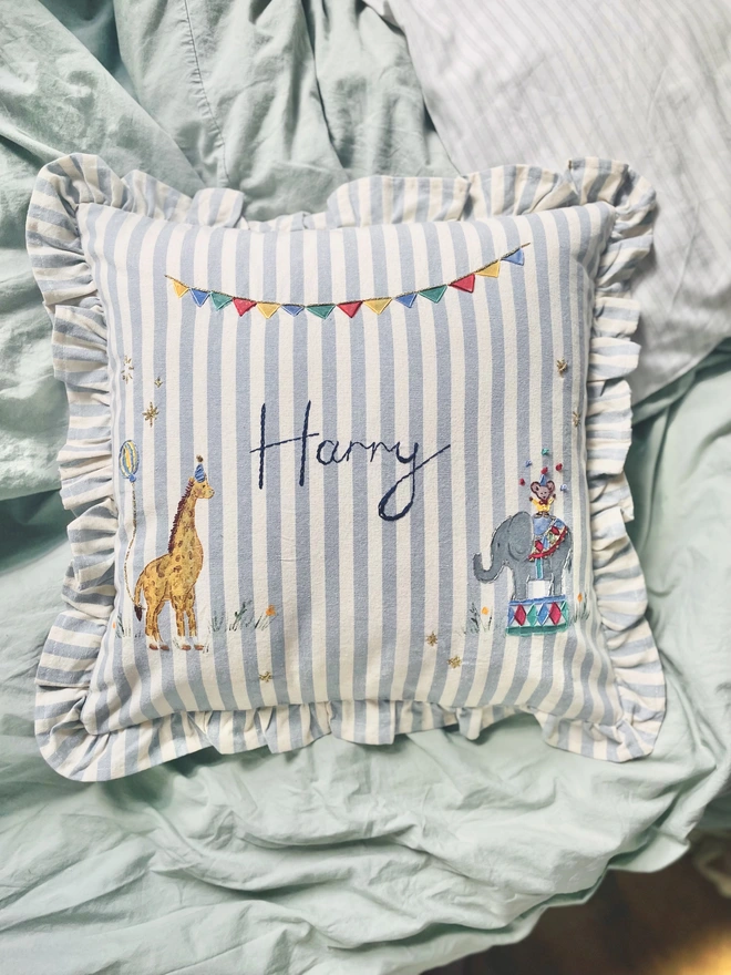 Hand Painted Giragge and ELephant celebrating the joy of the circus. Blue striped ruffle cushion with hand embroidered personalised name in the centre
