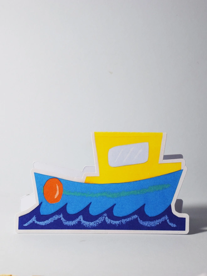 A cut out card of a boat