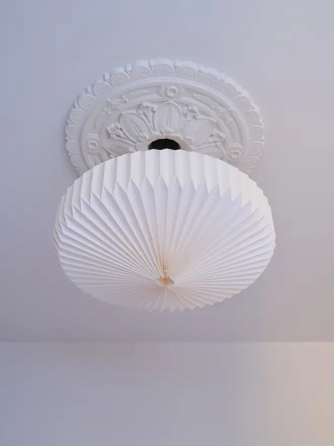 White origami lightshade hanging from ceiling 