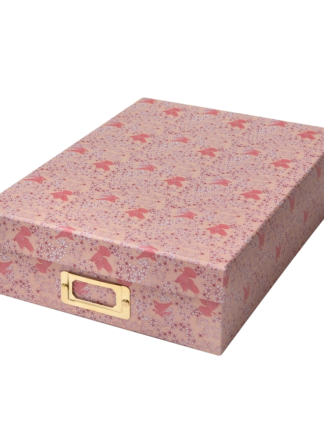 Corali Sand Pink Portfolio Box, a colourful portfolio sitting on a plan surface.