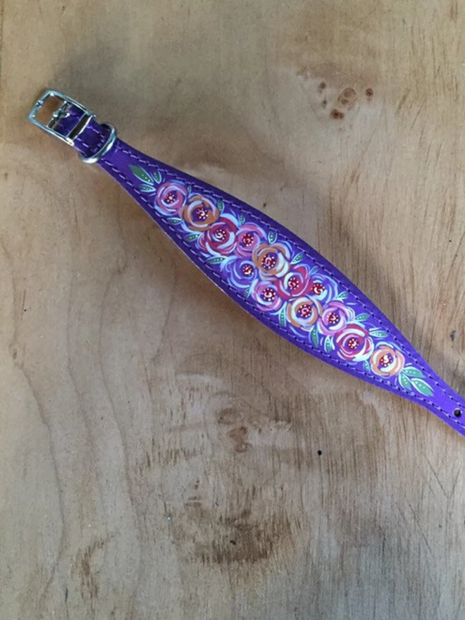 sleeping greyhound wearing purple floral hand painted leather collar