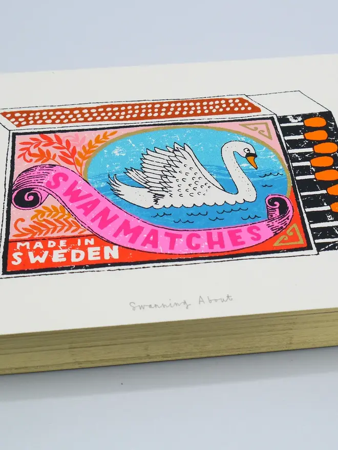 Swan Vintage Matchbox Screenprint Swanning About, a colourful swan matchbox design in the centre of a white card. 