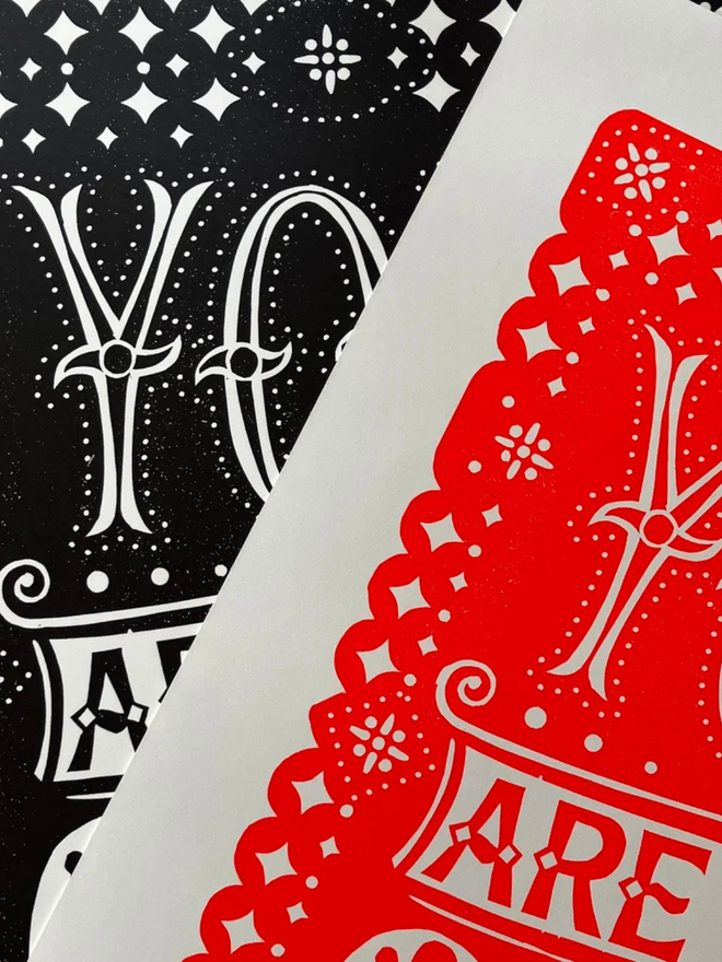 you are the one linocut. a linocut phrase printed on black and red paint.