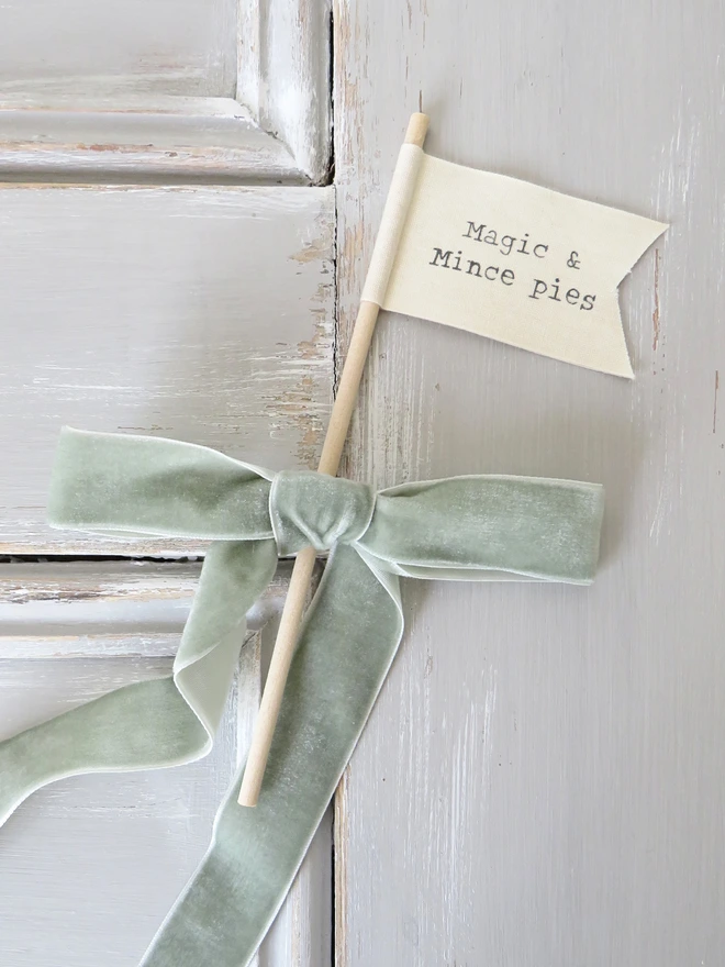 Organic cotton flag hand painted with festive message wrapped around wooden dowel