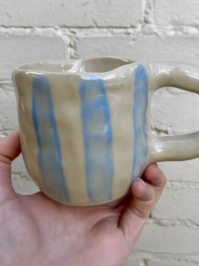 handmade ceramic smiley face blue white strip mug