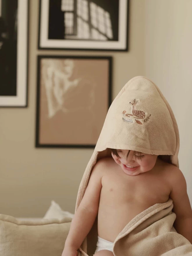 A hooded towel worn by a baby after bath