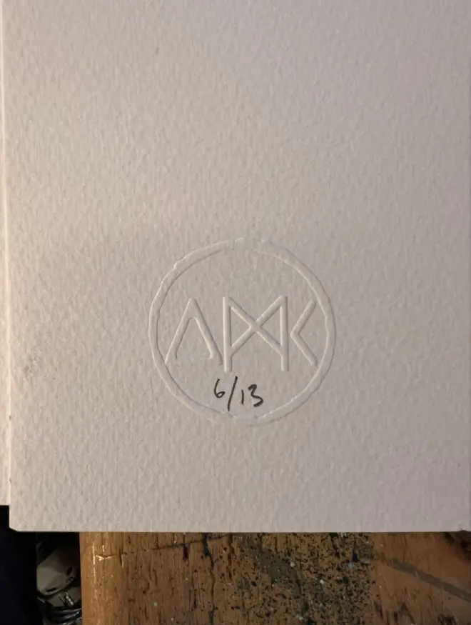 Punk budgie lino print, with symbols, coloured with blue and pink paint with on a white background. 