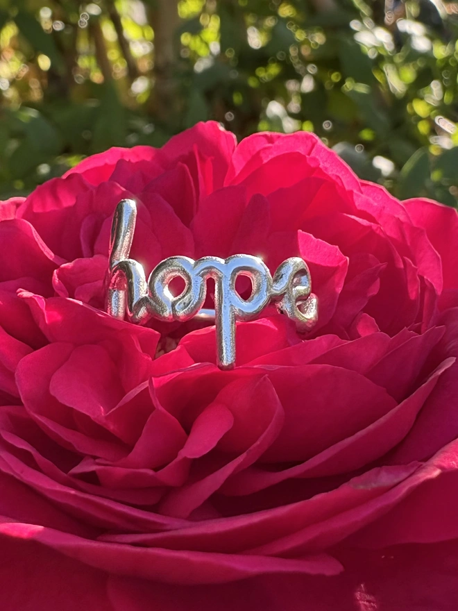Ring that says 'Hope' in sterling silver in a rose