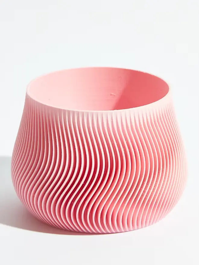 Sustainable 3D Printed Sakura Pink Plant Pot, groovy design against a white background. 