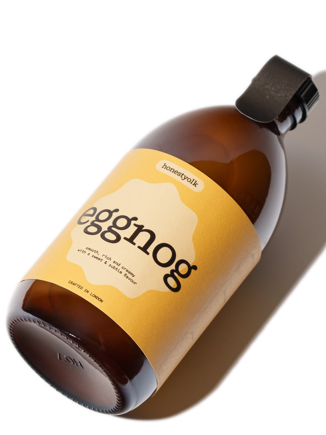 Honestyolk bottle lying down with a shadow