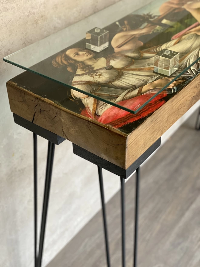 artwork print of lady on a glass top console table