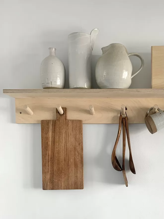 rack for the kitchen with ceramic jugs and utensils