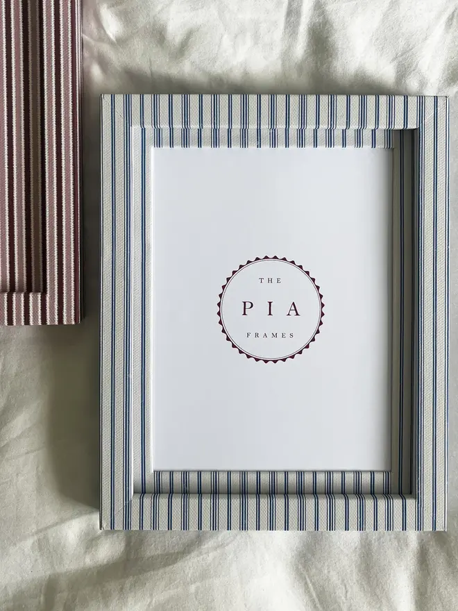 Rustic Blue Stripe Frame, a striped colourful frame sitting on a plain white surface. It is joined by another frame 