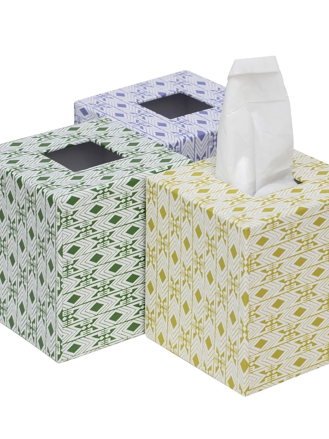 Tijan Tissue Box Cover, a group of colourful tissue boxes sitting on a white surface. 