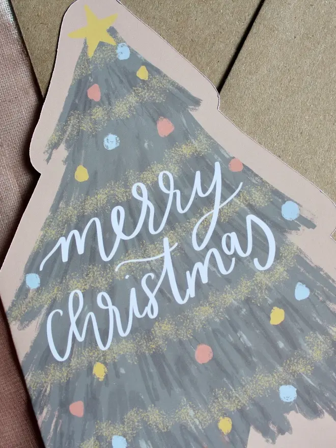illustrated christmas tree card. illustrated christmas tree made into a card emblazoned with 'merry christmas'. 