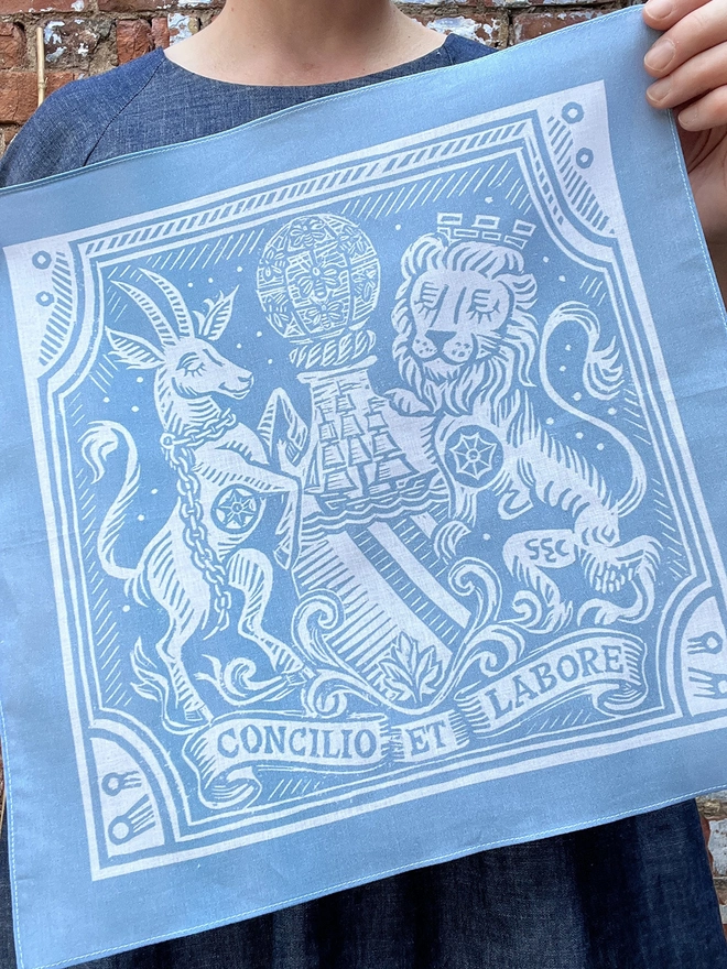 A Mr.PS Manchester Coat of Arms Heraldic Handkerchief being held