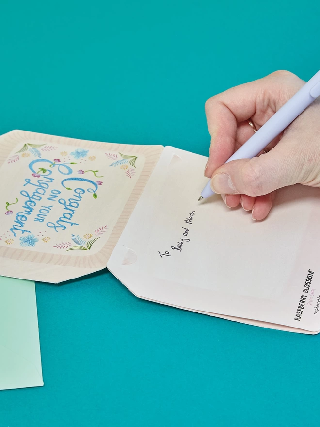 The card is folded out and has a large space on the back for your own joyful engagement message to the happy couple
