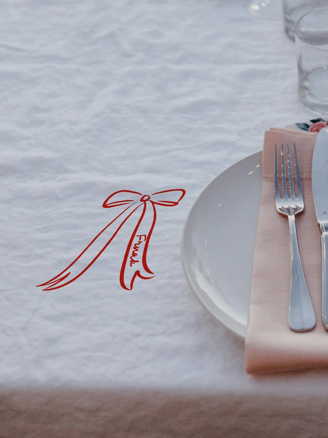 personlaised Bow tablecloth place name sticker red on a white tablecloth