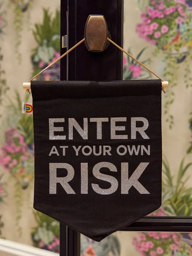 Enter at your own risk banner
