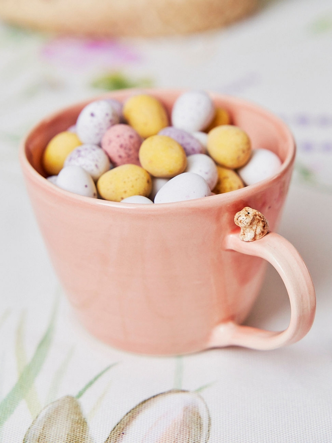 Pink bunny cup filled with eggs