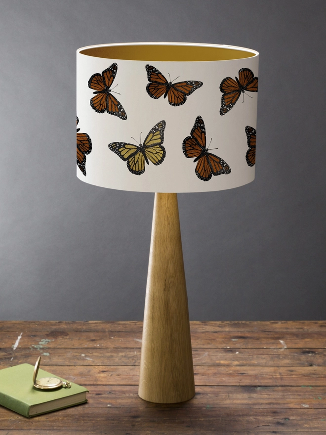 Mountain & Molehill monarch butterfly shade with gold detail on wood lamp base