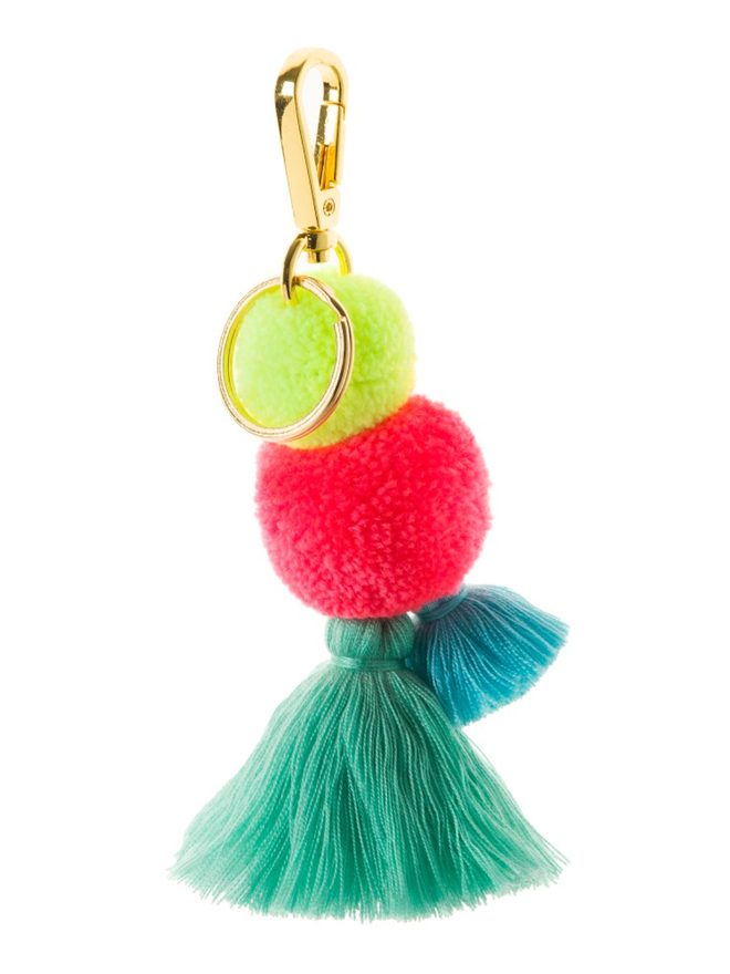 pom pom and tassel keyring. a keyring with a neon green and pink pom pom and turqouise tassels.