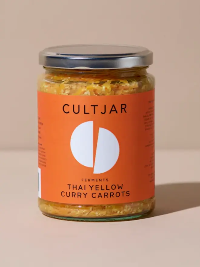 jar of yellow carrot ferment with orange label