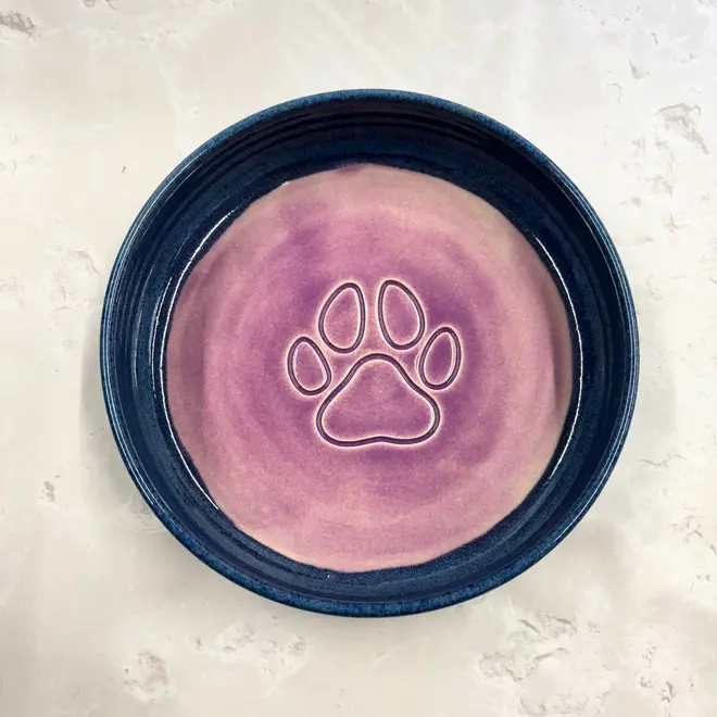 Landscape Dog Bowl, a colourful dog bowl sitting on a stone surface. 