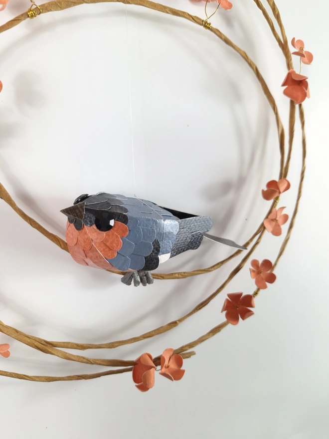 close up of a bullfinch paper sculpture, handmade by Kaper