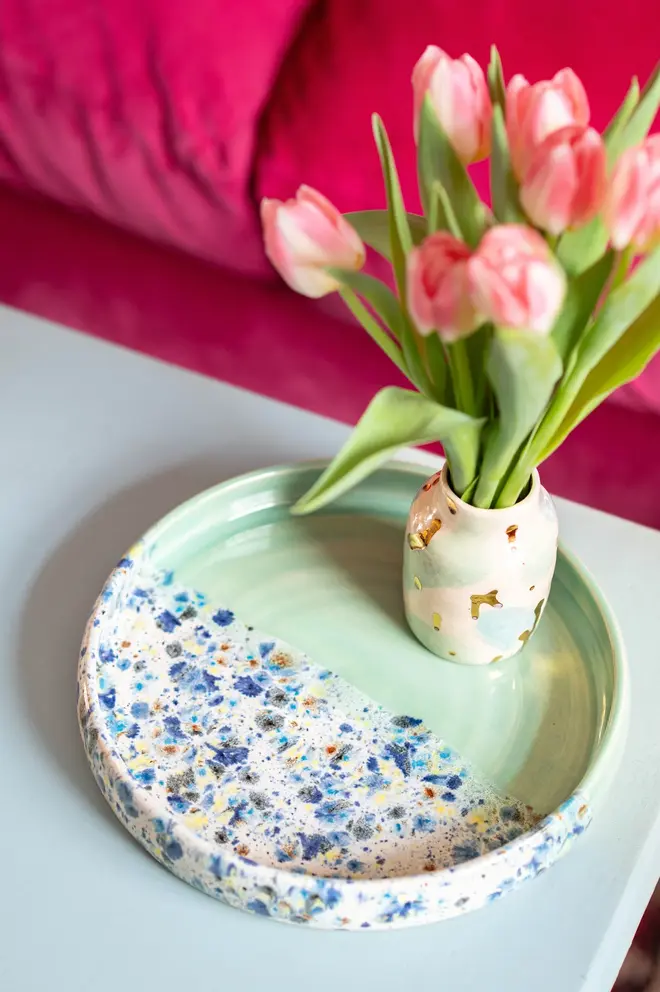 Shoreline Tray, a colourful tray placed on a table side accompanied by flowers. 