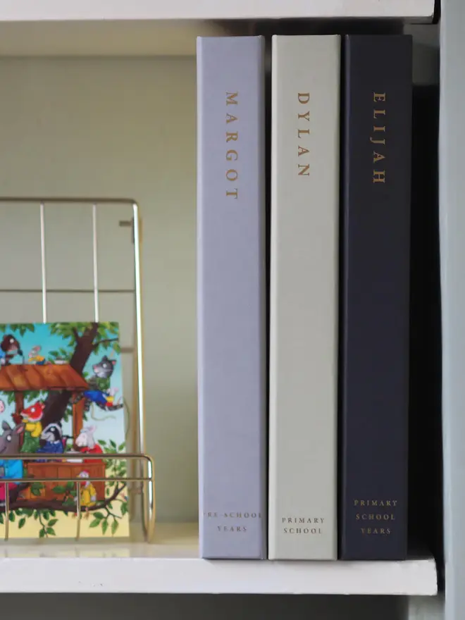 personalised keepsake ring binder. three personalised ring binders on a shelf, lined up to show the spines.