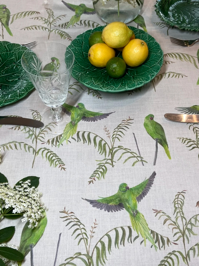 Parakeet tablecloth. A tablecloth patterned with light green parakeets.