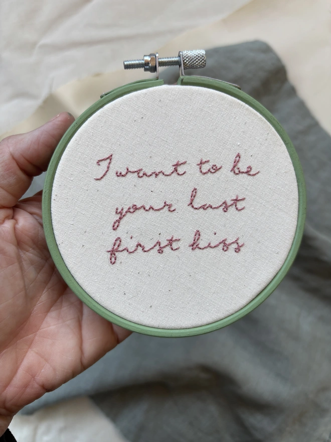 I want to be your last first kiss hand embroidered lettering in pink thread on natural calico in green hoop