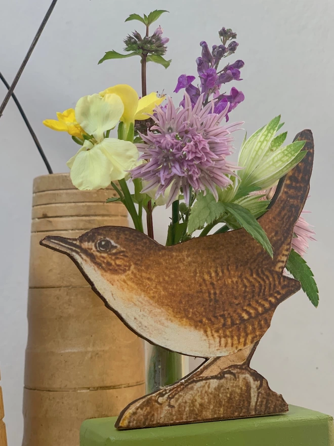Close up of a bud vase with a wren
