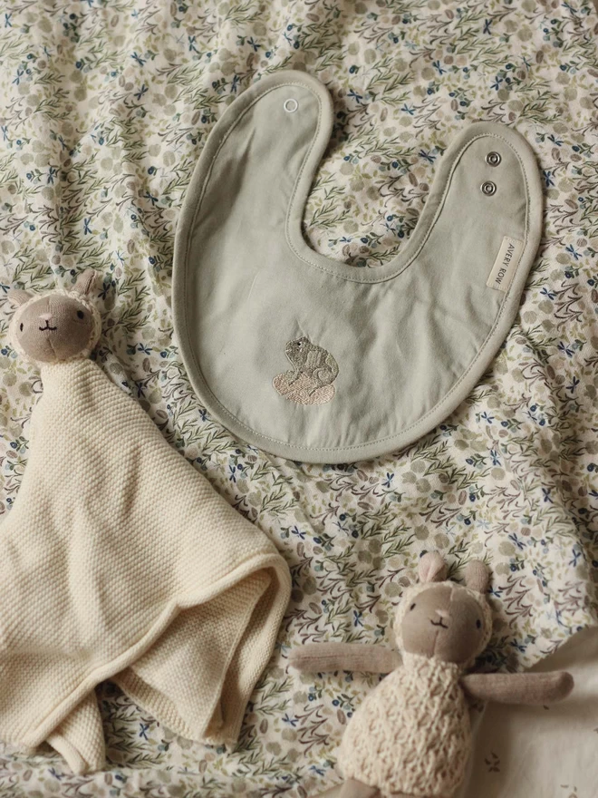 Embroidered cotton bib in frog design together with cuddle cloth and small toy sheep