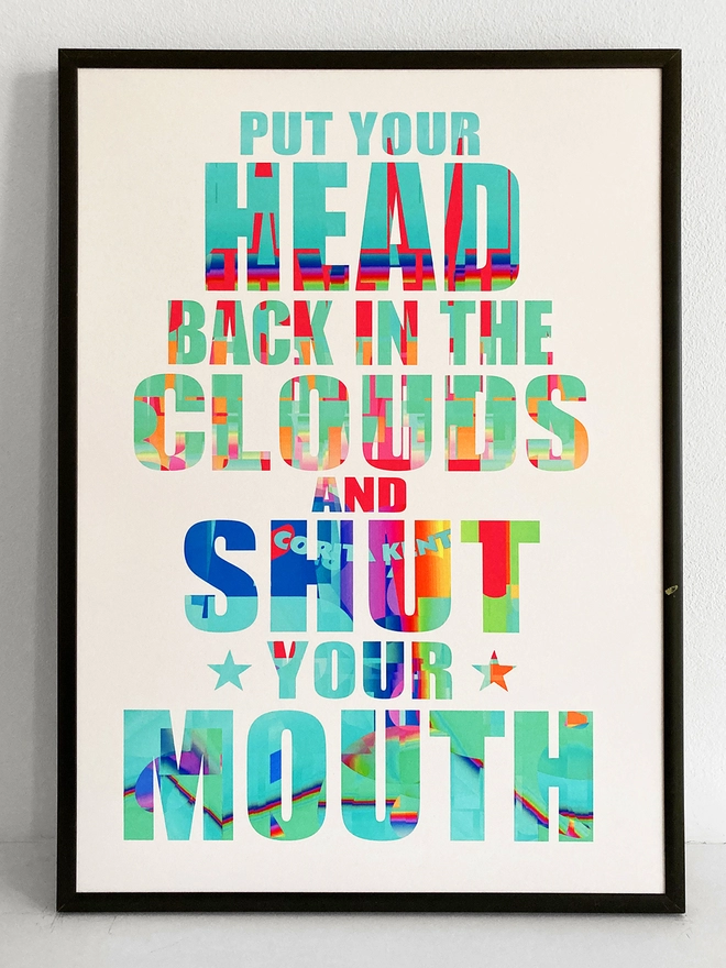 Framed multicoloured typographic print of a Julian Cope song, “put your head back in the clouds and shut your mouth”.