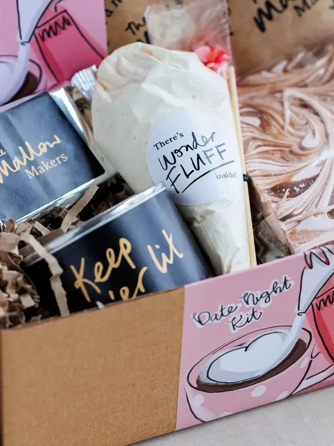 Date Night S'mores And Hot Chocolate Kit, the kit packaged in to a box on a marble surface. 