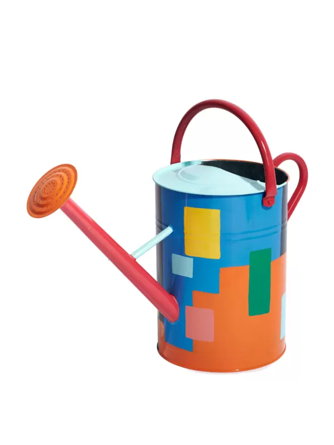Sky Blue, Orange and rhubarb red patch work style painted watering can. Nozzle is orange, handles are rhubarb red. Photographed from the front.