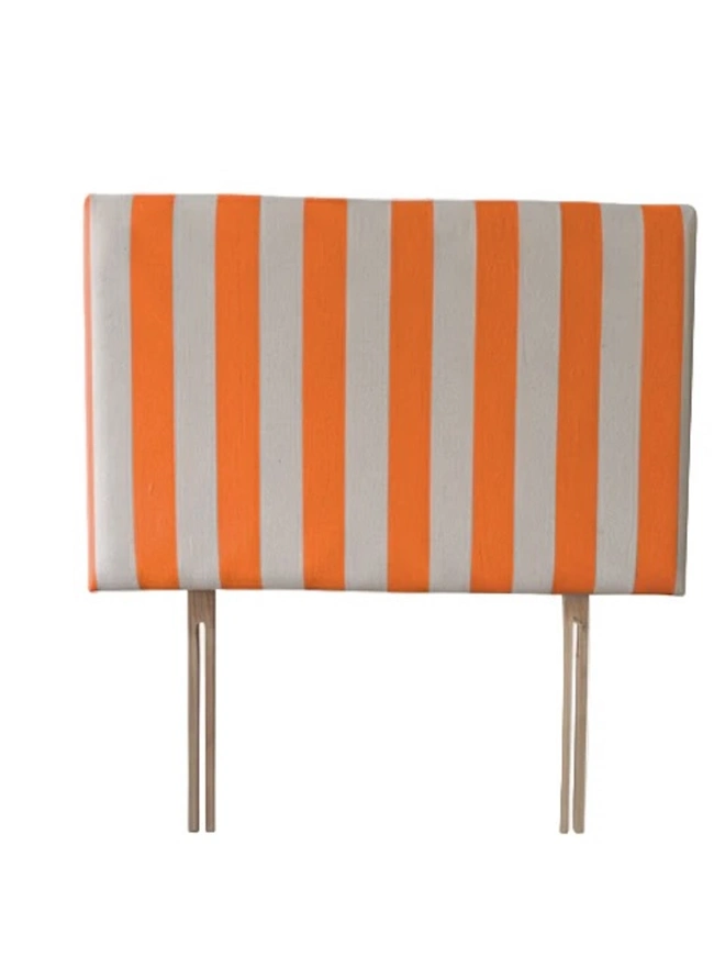 Hand Painted Upholstered Linen Headboard In Stripe Print, a neon orange striped headboard sitting against a white background. 
