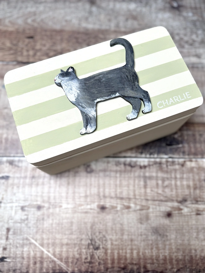 sage greeb and cream striped small wooden keepsake box with a hand - painted grey cat and the name Charlie painted on