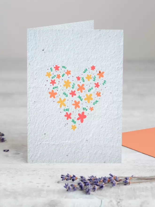Seeded Paper Greeting Card with a heart made out floral illustrations in the centre with a sprig of Lavender placed in the foreground of the image