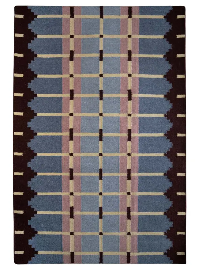 Corbie Flatweave Rug, a colourful rug sitting on a white plain surface. 