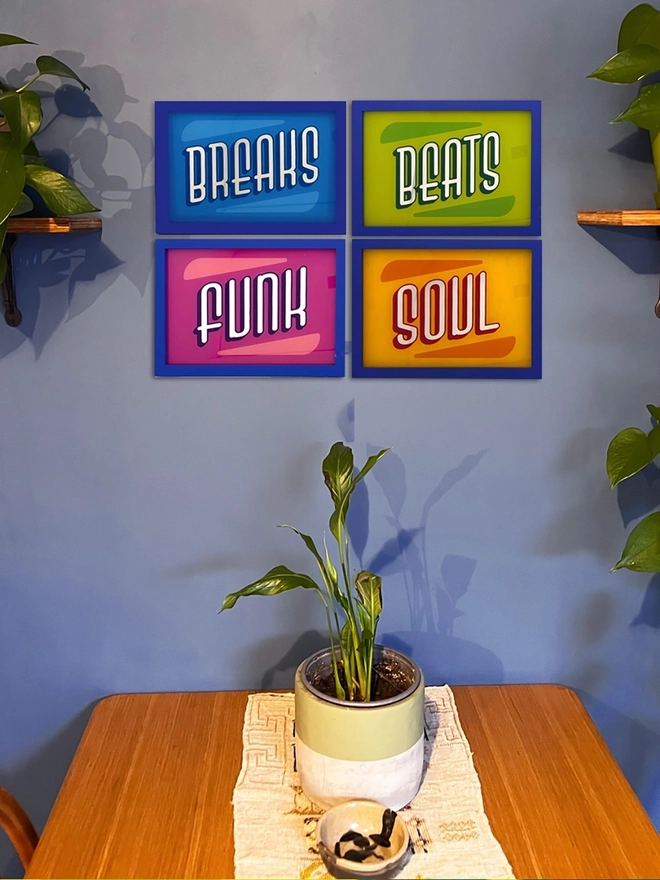 'Breaks, Beats,Funk, Soul' Gold Leaf Glass Artwork, against a Blue wall. 