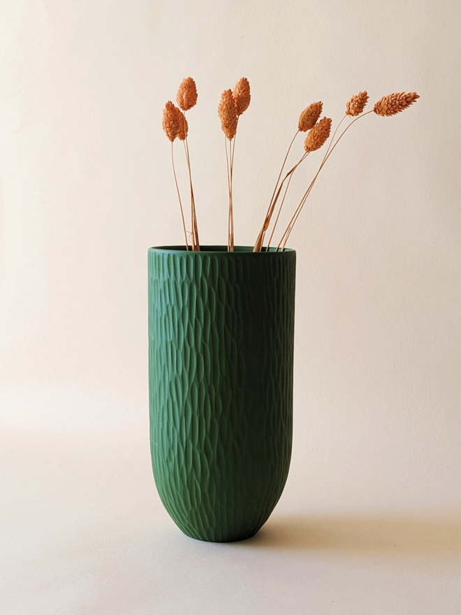 handmade textured dark green vase with dried flowers