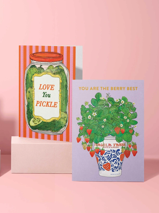 Colourful food-inspired greeting cards on display, featuring the stripe Love you pickle card featuring a pickled gherkin jar 