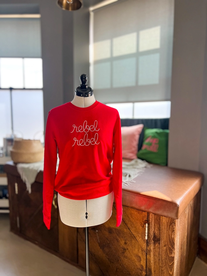 A red sweatshirt embroidered with rebel rebel