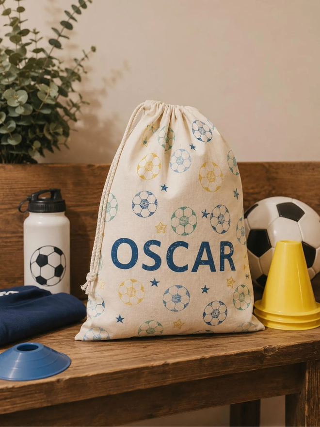 personalised football bag. a drawstring bag with printed footballs and a personalised name.