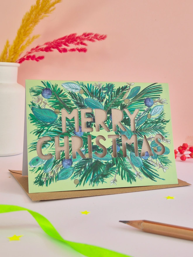 Pine fur and blue berry Christmas card with Merry Christmas text and shimmering mink pearlescent backing paper 