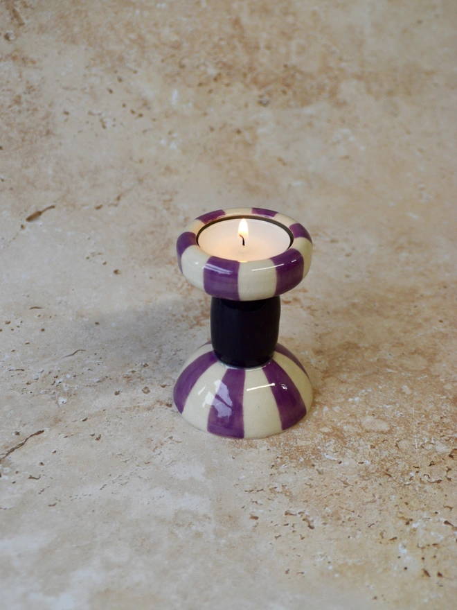 Single handmade striped ceramic candlestick holder in purple and cream tones