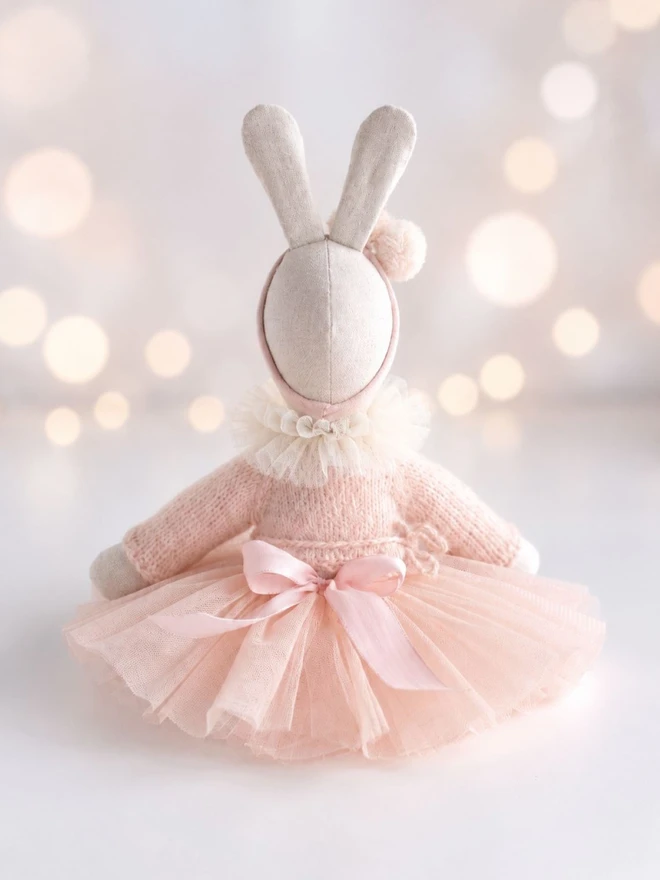 Back view of Verity ballerina bunny showing the pale pink tutu, knitted cardigan and satin bow.